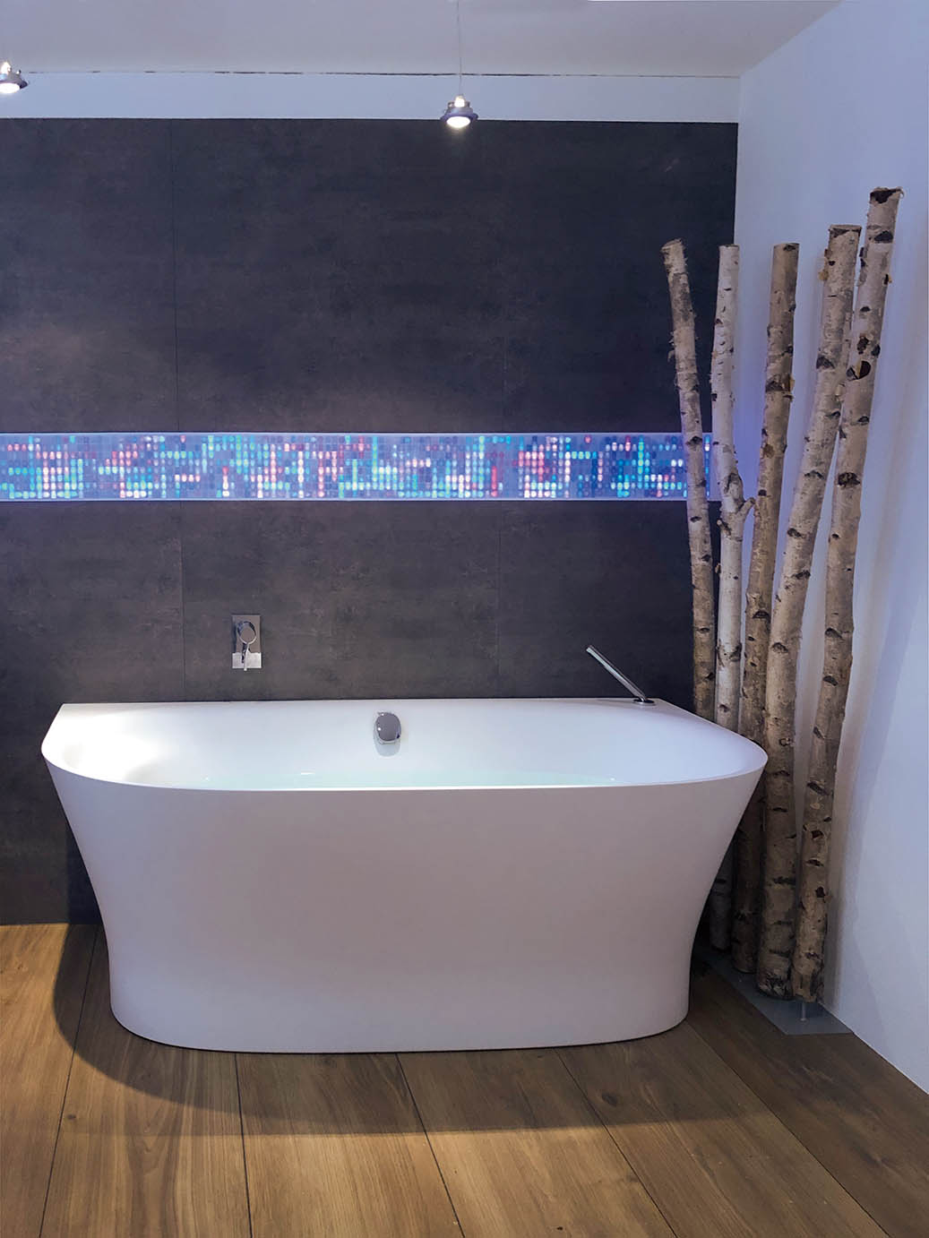 Image from Luminous Concepts photo gallery showing colorful volatiles installed in a bathroom environment with standalone bath tub and decorative wood pieces